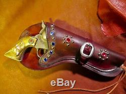 Vintage Western Toy Cap Gun called The Cowboy with jeweled studded holster