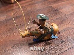 Vintage tin japan wind-up bar-x ALPS western cowboy with gun and lasso on horse